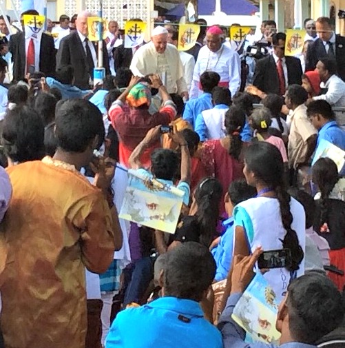 Pope Francis is surrounded by well-wishers as he enters the enclsoure of war victims and sick at the Madhu shrine. Pope Francis is surrounded by well-wishers as he enters the enclsoure of war victims and sick at the Madhu shrine.
