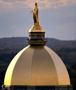A statue of the Blessed Mother stands atop the golden dome of the Main Building. A statue of the Blessed Mother stands atop the golden dome of the Main Building.