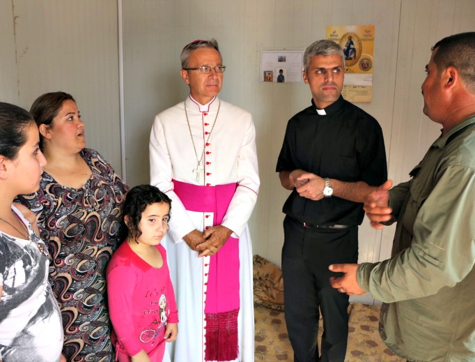 From top: Bishop Francesco Cavina of Carpi, Italy, meets with a Syriac Orthodox family who have been in the Dawudiya Refugee Camp near Duhok for 14 months. Haney, an 86-year-old Syriac Catholic, was kidnapped along with her son by Islamic State forces. After being released, they fled to Duhok then to Dawudiya, in Iraqi Kurdistan. Sadalla and his family fled from his town outside Mosul to escape from ISIS. They have taken refuge at the catechesis center in Mangesh for more than two years. ‘God willing, we’ll be able to go back to our home town soon. Until ISIS invaded, we lived with Muslims and Yazidis without any problems.’ Illuminated crosses adorn almost every caravan at the Asti 2 refugee camp in Ankawa, Erbil, Iraq, the largest Christian camp in Kurdistan. From top: Bishop Francesco Cavina of Carpi, Italy, meets with a Syriac Orthodox family who have been in the Dawudiya Refugee Camp near Duhok for 14 months. Haney, an 86-year-old Syriac Catholic, was kidnapped along with her son by Islamic State forces. After being released, they fled to Duhok then to Dawudiya, in Iraqi Kurdistan. Sadalla and his family fled from his town outside Mosul to escape from ISIS. They have taken refuge at the catechesis center in Mangesh for more than two years. ‘God willing, we’ll be able to go back to our home town soon. Until ISIS invaded, we lived with Muslims and Yazidis without any problems.’ Illuminated crosses adorn almost every caravan at the Asti 2 refugee camp in Ankawa, Erbil, Iraq, the largest Christian camp in Kurdistan.