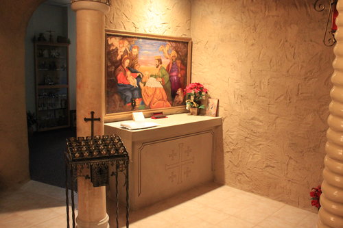 CHRISTMAS CHURCH. A painting by parishioner Carol Keith hangs above the Altar of the Magi in the Bethlehem Chapel. Father Halaiko’s dog, Lucky, joins the Wise Men as they worship the Christ Child. CHRISTMAS CHURCH. A painting by parishioner Carol Keith hangs above the Altar of the Magi in the Bethlehem Chapel. Father Halaiko’s dog, Lucky, joins the Wise Men as they worship the Christ Child.