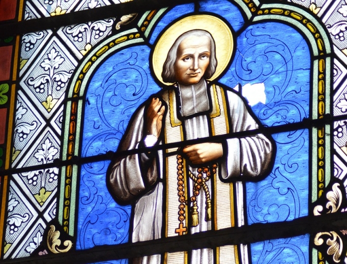 St. Jean Vianney is portrayed in a stained-glass window. St. Jean Vianney is portrayed in a stained-glass window.