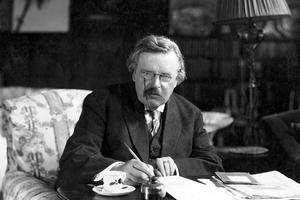 G.K. Chesterton works in his study. G.K. Chesterton works in his study.