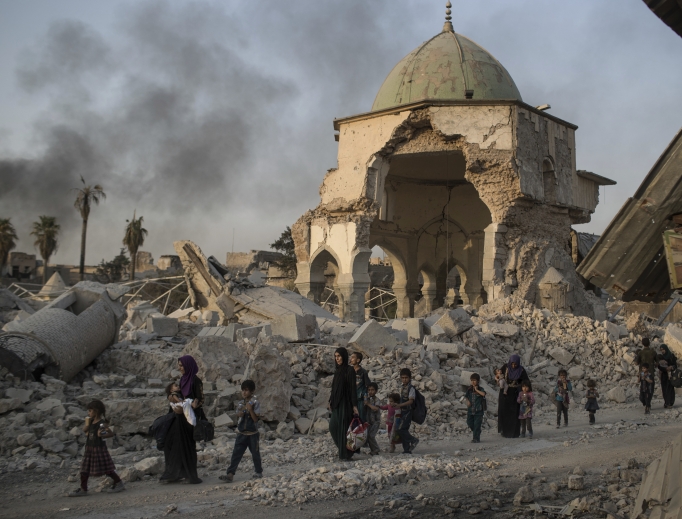 Fleeing Iraqi civilians walk past the heavily damaged al-Nuri mosque as Iraqi forces continue their advance against Islamic State militants in the Old City of Mosul, Iraq, July 4. Fleeing Iraqi civilians walk past the heavily damaged al-Nuri mosque as Iraqi forces continue their advance against Islamic State militants in the Old City of Mosul, Iraq, July 4.