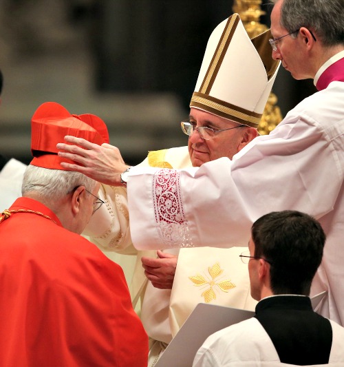 Cardinal Gualtiero Bassetti receives his biretta from Pope Francis during a consistory at St. Peter's Basilica on Feb. 22. Cardinal Gualtiero Bassetti receives his biretta from Pope Francis during a consistory at St. Peter's Basilica on Feb. 22.
