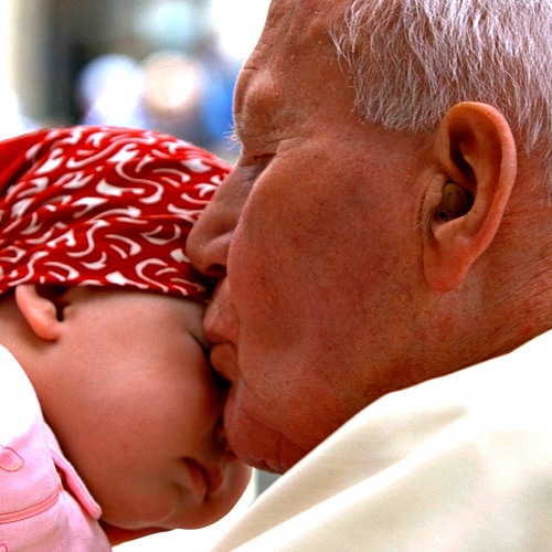 Pope John Paul II kisses a child as he leaves St. Peter's Square at the end of his weekly general audience at the Vatican on April 30, 2003. Pope John Paul II kisses a child as he leaves St. Peter's Square at the end of his weekly general audience at the Vatican on April 30, 2003.