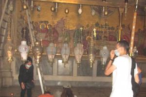 Closed for two months to stop the spread of the novel coronavirus, the Church of the Holy Sepulcher is now open to the public, but only 50 people at a time may pray inside. Above, pilgrims living in Israel pray in the Church of the Holy Sepulcher. Closed for two months to stop the spread of the novel coronavirus, the Church of the Holy Sepulcher is now open to the public, but only 50 people at a time may pray inside. Above, pilgrims living in Israel pray in the Church of the Holy Sepulcher.