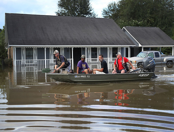 Richard Schafer navigates a boat past a flooded home on Aug. 15 in Baton Rouge, La. Record-breaking rains pelted Louisiana over the weekend, leaving the city with historic levels of flooding that have caused at least seven deaths and damaged thousands of homes. Richard Schafer navigates a boat past a flooded home on Aug. 15 in Baton Rouge, La. Record-breaking rains pelted Louisiana over the weekend, leaving the city with historic levels of flooding that have caused at least seven deaths and damaged thousands of homes.