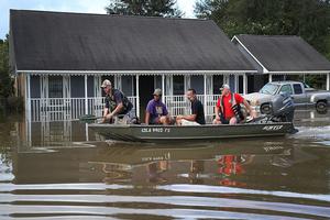 Richard Schafer navigates a boat past a flooded home on Aug. 15 in Baton Rouge, La. Record-breaking rains pelted Louisiana over the weekend, leaving the city with historic levels of flooding that have caused at least seven deaths and damaged thousands of homes. Richard Schafer navigates a boat past a flooded home on Aug. 15 in Baton Rouge, La. Record-breaking rains pelted Louisiana over the weekend, leaving the city with historic levels of flooding that have caused at least seven deaths and damaged thousands of homes.