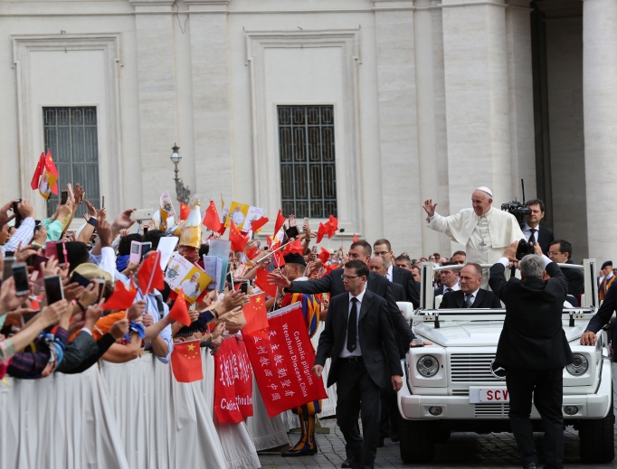 Pope Francis waves at pilgrims from China at a general audience in St. Peter’s Square. Pope Francis waves at pilgrims from China at a general audience in St. Peter’s Square.