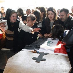People grieve at the coffins of two Christian brothers killed Nov. 22, during their funeral near Mosul, Iraq. Gunmen shot and killed the two Christians Nov. 23 in the northern Iraqi city in the latest in a spate of attacks targeting the religious minority, Iraqi police said. People grieve at the coffins of two Christian brothers killed Nov. 22, during their funeral near Mosul, Iraq. Gunmen shot and killed the two Christians Nov. 23 in the northern Iraqi city in the latest in a spate of attacks targeting the religious minority, Iraqi police said.