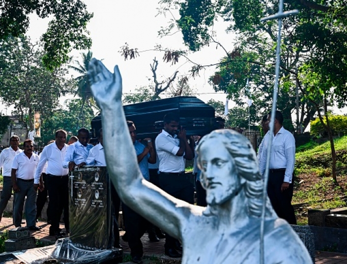 Relatives carry the coffin of a bomb blast victim during a burial ceremony at a cemetery in Colombo on April 24, three days after a series of suicide attacks targeting churches and luxury hotels in Sri Lanka that killed more than 350 people, despite prior intelligence warnings. Relatives carry the coffin of a bomb blast victim during a burial ceremony at a cemetery in Colombo on April 24, three days after a series of suicide attacks targeting churches and luxury hotels in Sri Lanka that killed more than 350 people, despite prior intelligence warnings.
