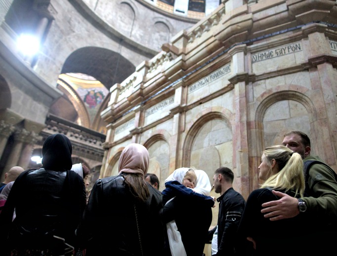 People visit the tomb of Jesus Christ, with the rotunda seen in the Church of the Holy Sepulcher on March 21 in Jerusalem. The tomb, in Jerusalem's Old City, is without its iron cage for the first time since it was placed around the stone tomb by the British in 1947 to keep the Edicule from falling apart.
People visit the tomb of Jesus Christ, with the rotunda seen in the Church of the Holy Sepulcher on March 21 in Jerusalem. The tomb, in Jerusalem's Old City, is without its iron cage for the first time since it was placed around the stone tomb by the British in 1947 to keep the Edicule from falling apart.
