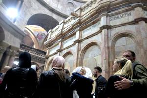People visit the tomb of Jesus Christ, with the rotunda seen in the Church of the Holy Sepulcher on March 21 in Jerusalem. The tomb, in Jerusalem's Old City, is without its iron cage for the first time since it was placed around the stone tomb by the British in 1947 to keep the Edicule from falling apart.
People visit the tomb of Jesus Christ, with the rotunda seen in the Church of the Holy Sepulcher on March 21 in Jerusalem. The tomb, in Jerusalem's Old City, is without its iron cage for the first time since it was placed around the stone tomb by the British in 1947 to keep the Edicule from falling apart.