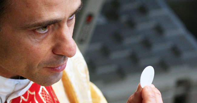 A priest gives Holy Communion on the Feast of the Holy Family in St. Peter's Basilica on December 27, 2015. A priest gives Holy Communion on the Feast of the Holy Family in St. Peter's Basilica on December 27, 2015.