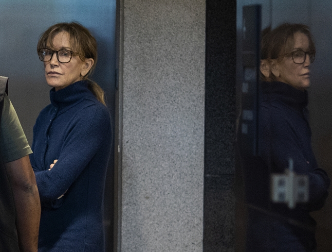 Actress Felicity Huffman is seen inside the Edward R. Roybal Federal Building and U.S. Courthouse in Los Angeles March 12. Hollywood actresses Huffman and Lori Loughlin are among 50 people indicted in a nationwide university-admissions scam, court records unsealed in Boston March 12 showed. A federal judge set bond at $250,000 for Huffman after she was charged in the cheating scandal. Actress Felicity Huffman is seen inside the Edward R. Roybal Federal Building and U.S. Courthouse in Los Angeles March 12. Hollywood actresses Huffman and Lori Loughlin are among 50 people indicted in a nationwide university-admissions scam, court records unsealed in Boston March 12 showed. A federal judge set bond at $250,000 for Huffman after she was charged in the cheating scandal.