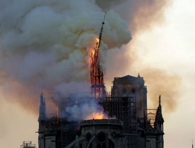 The steeple and spire of the Cathedral of Notre Dame collapses, as the cathedral is engulfed in flames in central Paris on April 15. The steeple and spire of the Cathedral of Notre Dame collapses, as the cathedral is engulfed in flames in central Paris on April 15.