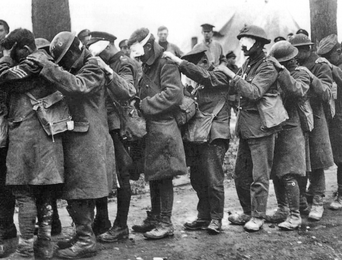 Above, a photograph shows British 55th Division soldiers blinded by tear gas during the Battle of Estaires April 10, 1918; via Imperial War Museums archive. Below, The Last General Absolution of the Munster Fusiliers at Rue du Bois painting was commissioned by Jessie Louisa Rickard; the original was destroyed during the bombing of London in World War II. It was originally published in The Sphere Nov. 27, 1916 (British Library information). Above, a photograph shows British 55th Division soldiers blinded by tear gas during the Battle of Estaires April 10, 1918; via Imperial War Museums archive. Below, The Last General Absolution of the Munster Fusiliers at Rue du Bois painting was commissioned by Jessie Louisa Rickard; the original was destroyed during the bombing of London in World War II. It was originally published in The Sphere Nov. 27, 1916 (British Library information).