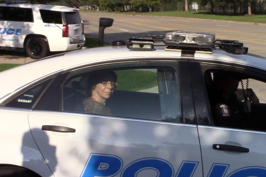 Dr. Monica Migliorino Miller sits in the back of a police car after her arrest Dr. Monica Migliorino Miller sits in the back of a police car after her arrest