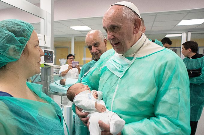 Pope Francis holds a baby in the neonatal unit of San Giovanni Hospital on Sept. 16. Pope Francis holds a baby in the neonatal unit of San Giovanni Hospital on Sept. 16.