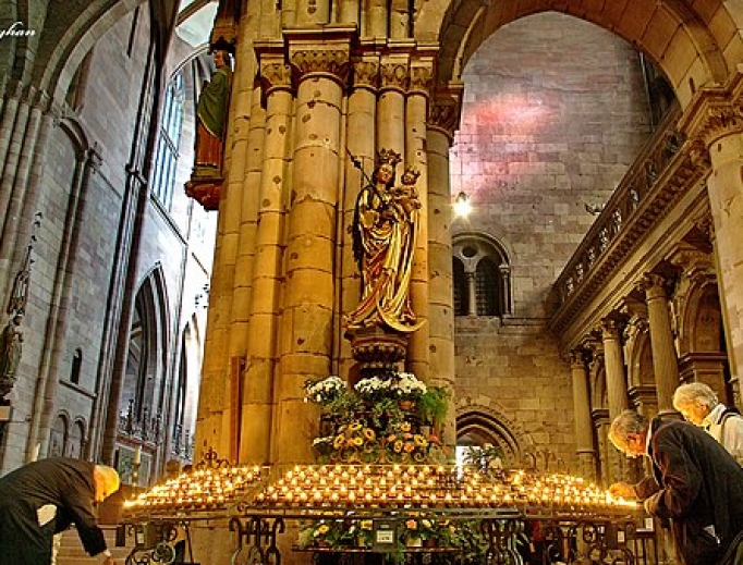Parishioners light candles inside a Catholic church in Freiburg. Parishioners light candles inside a Catholic church in Freiburg.