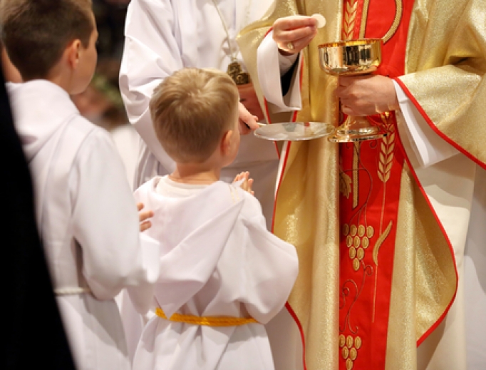 Young children receiving first Holy Communion. Young children receiving first Holy Communion.