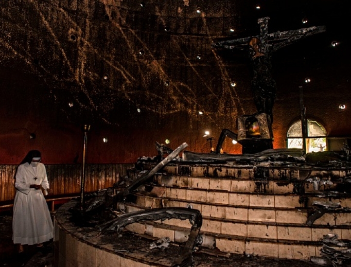 A nun prays next to the charred remains of the image of "Christ's Blood" after an attack with a Molotov cocktail at the Cathedral in Managua on July 31, 2020. A nun prays next to the charred remains of the image of "Christ's Blood" after an attack with a Molotov cocktail at the Cathedral in Managua on July 31, 2020.