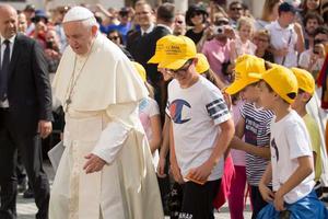 Pope Francis walks with young people during his general audience June 13. Pope Francis walks with young people during his general audience June 13.