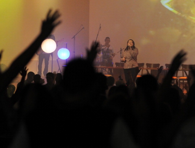 A singer performs during a religious ceremony for young people at an evangelical church in Brasilia. A singer performs during a religious ceremony for young people at an evangelical church in Brasilia.