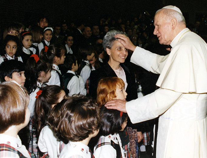 Pope St. John Paul II greets a teacher and schoolchildren in 1994 at the Paul VI Audience Hall at the Vatican. Pope St. John Paul II greets a teacher and schoolchildren in 1994 at the Paul VI Audience Hall at the Vatican.