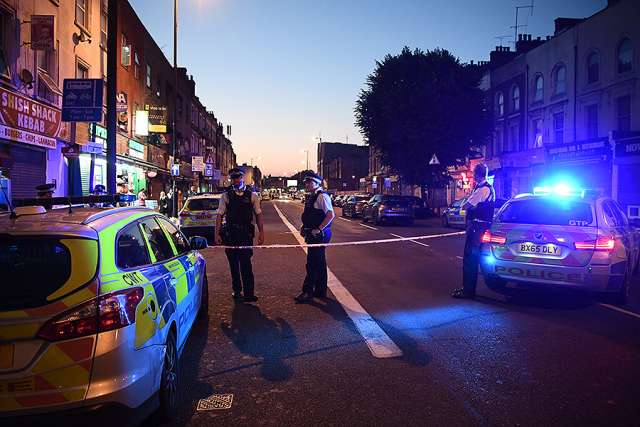 Police officers guard a road leading to Finsbury Park Mosque after a van hit worshippers outside the building on June 19 in London. Police officers guard a road leading to Finsbury Park Mosque after a van hit worshippers outside the building on June 19 in London.