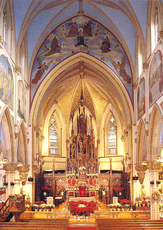 In this photograph of the sanctuary of St. John’s in Orange, NJ, you can see both of the images I refer to in my homily: the painting of Christ glorified in heaven over the arch (the subject is the coronation of the Blessed Virgin) and the large crucifixion scene behind the ambo. (In my homily I say the crucifixion is on my right. That’s because this is an older photograph; the ambo has been moved and the stairs retired. Other than that and some water damage to the ceiling, the church looks pretty much the same.) In this photograph of the sanctuary of St. John’s in Orange, NJ, you can see both of the images I refer to in my homily: the painting of Christ glorified in heaven over the arch (the subject is the coronation of the Blessed Virgin) and the large crucifixion scene behind the ambo. (In my homily I say the crucifixion is on my right. That’s because this is an older photograph; the ambo has been moved and the stairs retired. Other than that and some water damage to the ceiling, the church looks pretty much the same.)