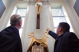 Above, Fathers Fredy Angel and Jack Wall admire the life-size crucifix in the sanctuary of the new church of St. Anthony of Padua Church that Catholic Extension helped to build. Below, Bishop Joseph Tyson celebrates Mass for migrant workers and children in the fields in rural Washington state. Above, Fathers Fredy Angel and Jack Wall admire the life-size crucifix in the sanctuary of the new church of St. Anthony of Padua Church that Catholic Extension helped to build. Below, Bishop Joseph Tyson celebrates Mass for migrant workers and children in the fields in rural Washington state.