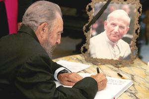 Cuban President Fidel Castro, shown signing the book of condolences at the nunciature in Havana on April 4, 2005, after the death of Pope John Paul II, welcomed the Polish Pope to Cuba in 1998. Castro declared Christmas Day a national holiday in Cuba that year. Cuban President Fidel Castro, shown signing the book of condolences at the nunciature in Havana on April 4, 2005, after the death of Pope John Paul II, welcomed the Polish Pope to Cuba in 1998. Castro declared Christmas Day a national holiday in Cuba that year.