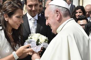  Pope Francis greets a newly married couple in St. Peter's Square on Sept. 16.