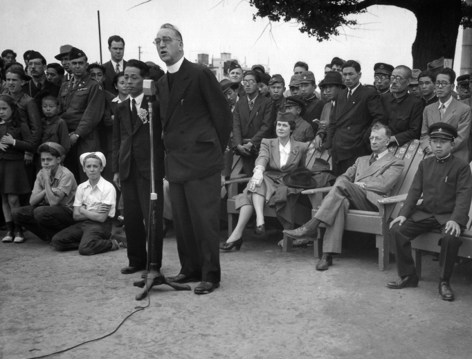 Father Edward Flanagan, founder of Boys Town, Nebraska, speaks into a microphone at Meiji Stadium in Tokyo May 28, 1947, during a Japanese Boy Scout jamboree. At right, wearing his school uniform, is Crown Prince Akahito.
Father Edward Flanagan, founder of Boys Town, Nebraska, speaks into a microphone at Meiji Stadium in Tokyo May 28, 1947, during a Japanese Boy Scout jamboree. At right, wearing his school uniform, is Crown Prince Akahito.