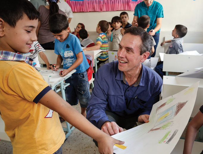 Sean Callahan (also shown below) speaks with young Syrian refugees at a school in Zarqa, Jordan. Sean Callahan (also shown below) speaks with young Syrian refugees at a school in Zarqa, Jordan.