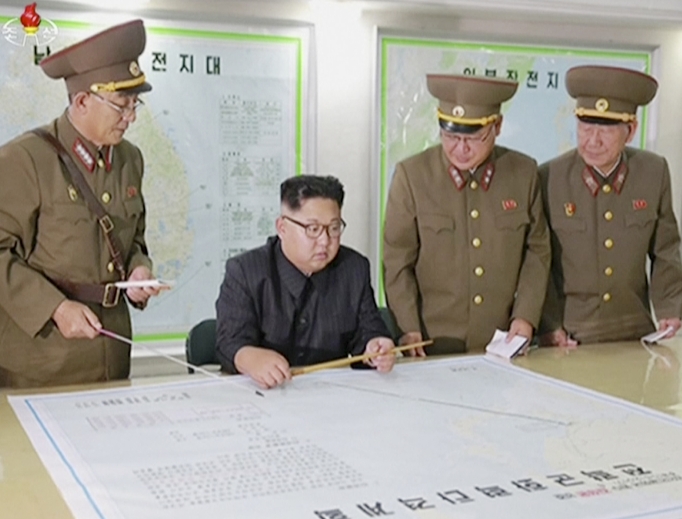 This image made from video of an Aug. 14 still image broadcast in a news bulletin on Aug. 15 by North Korea's KRT shows North Korean leader Kim Jong Un receiving a briefing in Pyongyang. North Korea said the leader was briefed on his military's plans to launch missiles in waters near Guam days after the Korean People's Army announced its preparing to create "enveloping fire" near the U.S. military hub in the Pacific. Independent journalists were not given access to cover the event depicted in this photo. This image made from video of an Aug. 14 still image broadcast in a news bulletin on Aug. 15 by North Korea's KRT shows North Korean leader Kim Jong Un receiving a briefing in Pyongyang. North Korea said the leader was briefed on his military's plans to launch missiles in waters near Guam days after the Korean People's Army announced its preparing to create "enveloping fire" near the U.S. military hub in the Pacific. Independent journalists were not given access to cover the event depicted in this photo.