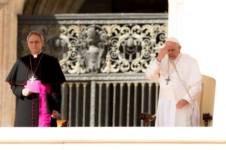 Pope Francis prays, making the Sign of the Cross, at the end of his general audience March 14. Pope Francis prays, making the Sign of the Cross, at the end of his general audience March 14.