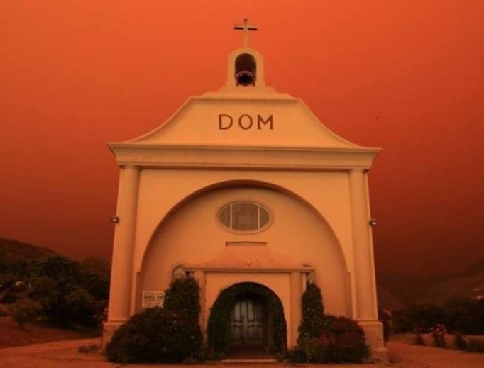 St. Vincent de Paul parish in Davenport, California, surrounded by an orange glow from an approaching fire. St. Vincent de Paul parish in Davenport, California, surrounded by an orange glow from an approaching fire.