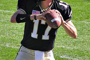 Father Thomas Haan on the gridiron as a Purdue quarterback, above, and below (far right) on the day of his ordination to the priesthood. Father Thomas Haan on the gridiron as a Purdue quarterback, above, and below (far right) on the day of his ordination to the priesthood.