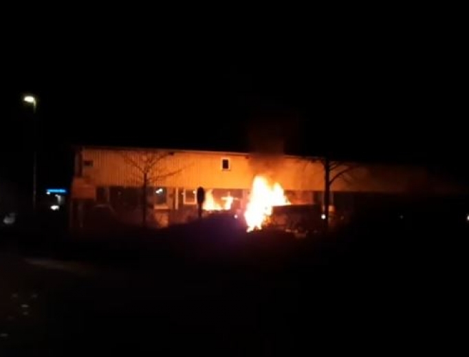 A vehicle on fire in front of a church in Tübingen. A vehicle on fire in front of a church in Tübingen.