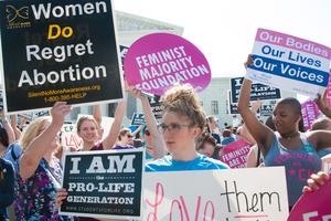 Pro-life and pro-choice activists await the Supreme Court's ruling on abortion access in front of the Supreme Court in Washington, DC on June 27, 2016. Pro-life and pro-choice activists await the Supreme Court's ruling on abortion access in front of the Supreme Court in Washington, DC on June 27, 2016.