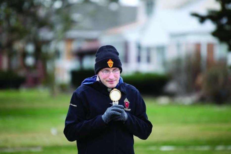 Fr. Bobby Krueger of St. Leonard in Berwyn, Illinois, carries the Blessed Sacrament throughout his parish when restrictions due to coronavirus pandemic shutdown parish activities. Fr. Bobby Krueger of St. Leonard in Berwyn, Illinois, carries the Blessed Sacrament throughout his parish when restrictions due to coronavirus pandemic shutdown parish activities.