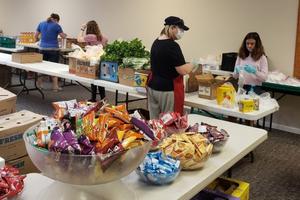 Volunteers and students prepare to open the Agape Food program at Kolbe Academy and Trinity Prep. Volunteers and students prepare to open the Agape Food program at Kolbe Academy and Trinity Prep.