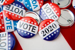 Voting buttons rest on an American flag. Voting buttons rest on an American flag.