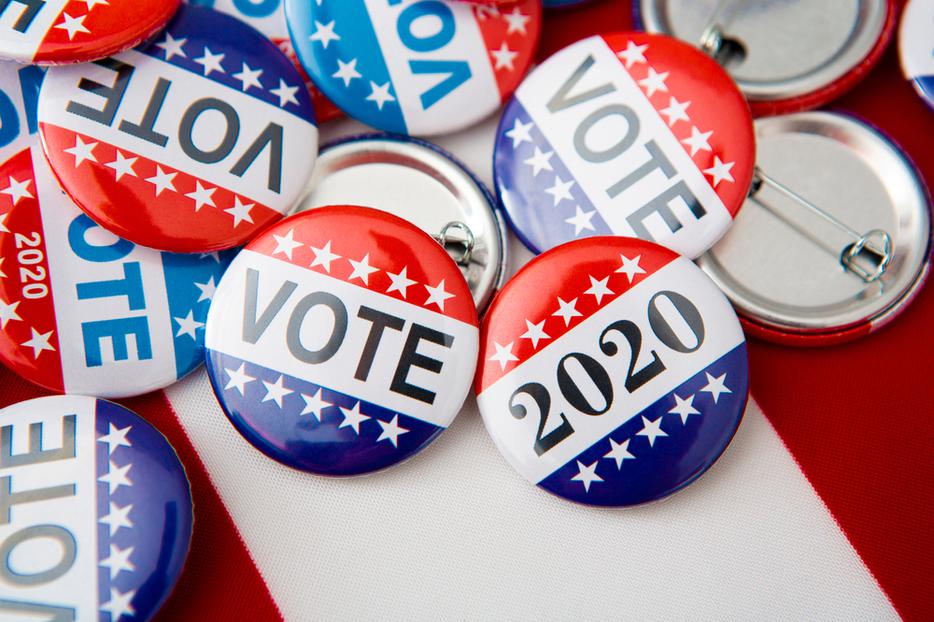 Voting buttons rest on an American flag. Voting buttons rest on an American flag.