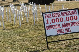 White crosses in front of a church in Lansdale, PA on March 14, 2019 with a sign that says "Each Cross Represents 1,000,000 Surgical Abortions Since 1973." White crosses in front of a church in Lansdale, PA on March 14, 2019 with a sign that says "Each Cross Represents 1,000,000 Surgical Abortions Since 1973."