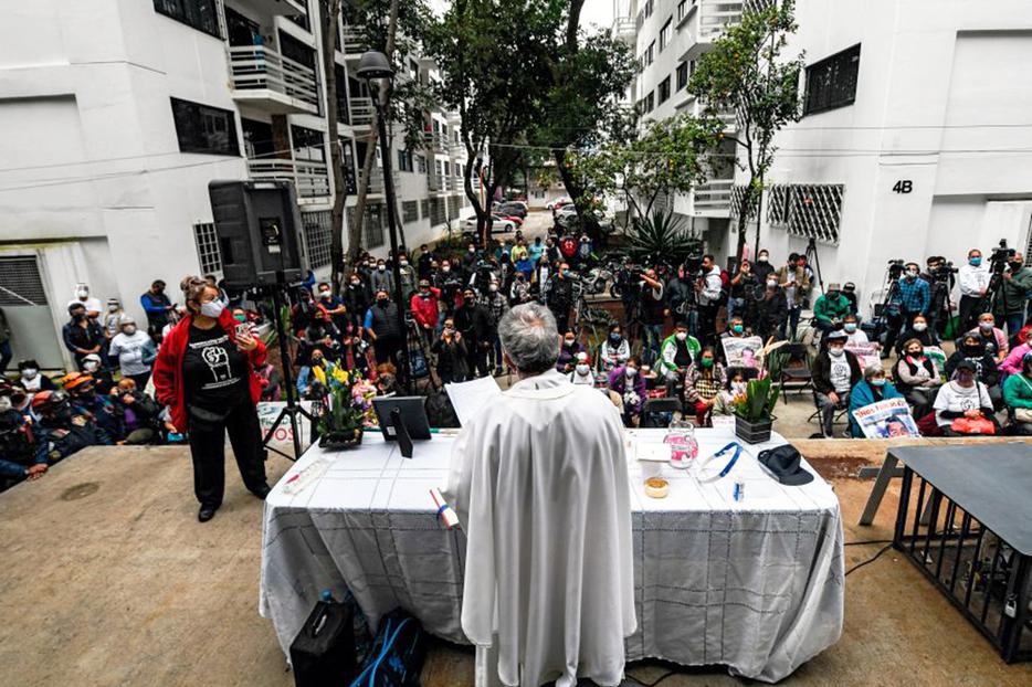 A priest offers Mass at the Tlalpan multifamily complex on the third anniversary of the earthquake that destroyed part of its buildings in Mexico City, on Sept. 19, 2020. A priest offers Mass at the Tlalpan multifamily complex on the third anniversary of the earthquake that destroyed part of its buildings in Mexico City, on Sept. 19, 2020.