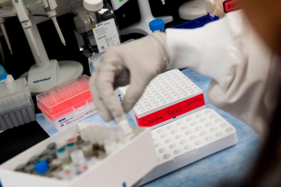 Dr. Nita Patel, director of antibody discovery and vaccine development, lifts a vial March 20 with a potential coronavirus vaccine at Novavax labs in Gaithersburg, Maryland. Novavax is one of the labs developing a vaccine for COVID-19. Dr. Nita Patel, director of antibody discovery and vaccine development, lifts a vial March 20 with a potential coronavirus vaccine at Novavax labs in Gaithersburg, Maryland. Novavax is one of the labs developing a vaccine for COVID-19.