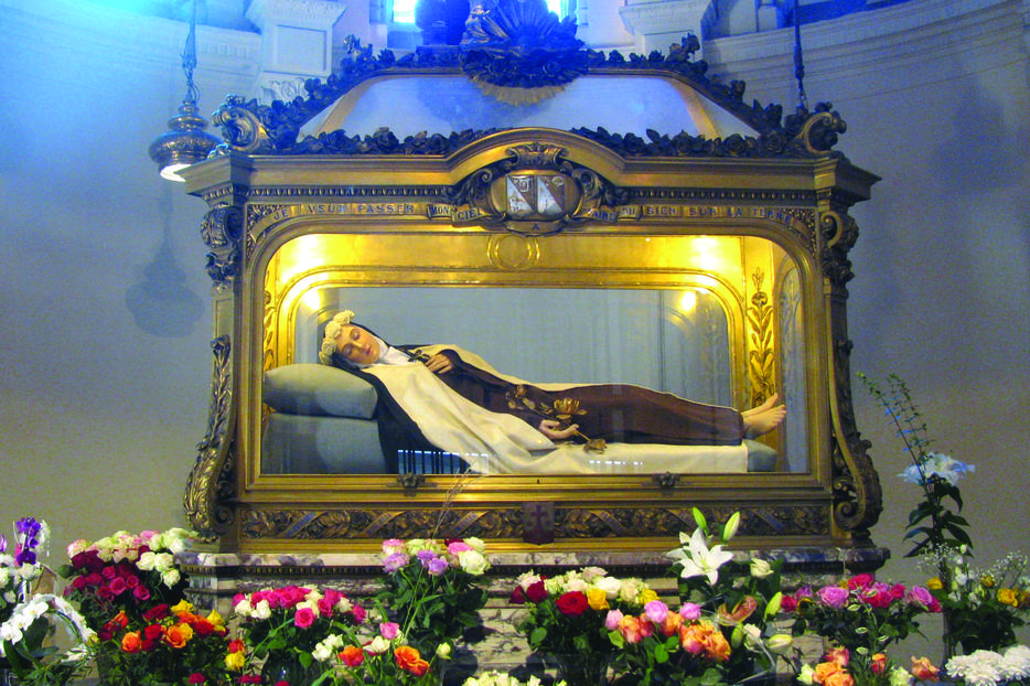 A walking visit of Lisieux takes pilgrims before Thérèse’s tomb at the convent. A walking visit of Lisieux takes pilgrims before Thérèse’s tomb at the convent.